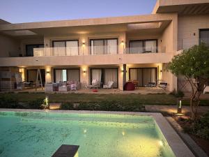 a house with a swimming pool in front of it at G cribs cozy studio in El Gouna