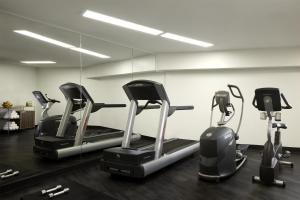 a row of treadmills in a gym with a mirror at NH Collection Buenos Aires Jousten in Buenos Aires