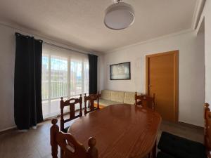 a living room with a wooden table and a couch at Casablanca in Miramar