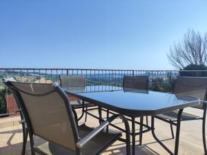 a table and chairs on a balcony with a view at Casale San Martino Agriturismo Bio in SantʼAngelo in Pontano