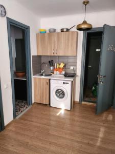 a kitchen with a stove and a washing machine at Bakuriani Art Hotel apartament in Bakuriani