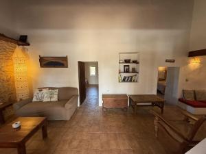 a living room with a couch and a table at Ca Na Vilda in Sant Ferran de Ses Roques
