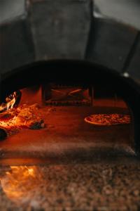 two pizzas are being cooked in an oven at Cala San Miguel Ibiza Resort, Adults only, Curio Collection by Hilton in Puerto de San Miguel