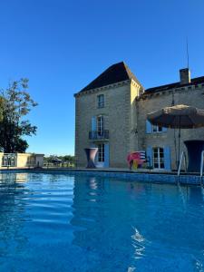 a large swimming pool in front of a building at Bordeaux Castle natural No2 in Quinsac