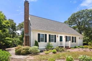 a white house with a chimney and black shutters at Next to Bike Trail Outdoor Adventure Awaits in Harwich