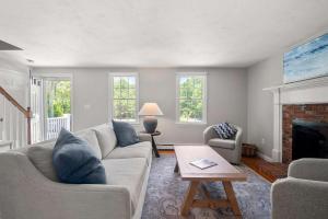 a living room with a couch and a fireplace at Next to Bike Trail Outdoor Adventure Awaits in Harwich