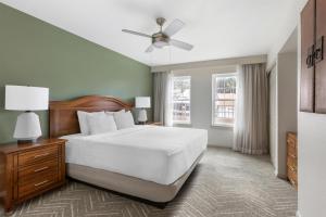 a bedroom with a white bed and a ceiling fan at Hilton Vacation Club Villas de Santa Fe in Santa Fe +37 photos