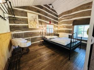 a room with two beds and a wooden wall at Les Ecuries du Lac in Weywertz +34 photos