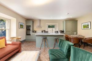 a kitchen and living room with a couch and a table at The Scarborough Suite in Marske