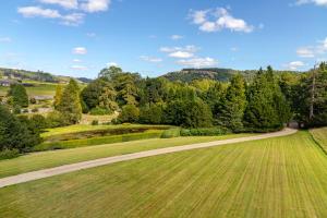 a grassy field with a dirt road at The Scarborough Suite in Marske +2 photos