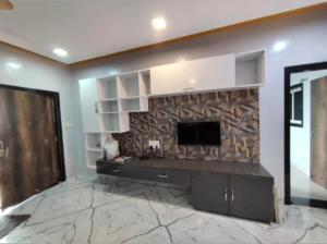 a living room with a tv and a stone fireplace at Luxury villa in Mumbai +5 photos