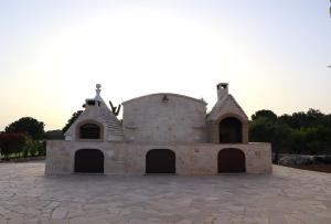 an old brick building on a stone patio at Dimora Sasa in Putignano