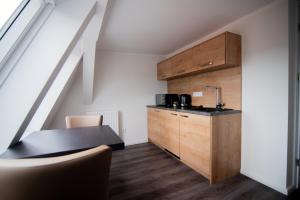 a small kitchen with a sink and a counter at Apartamenty Polonia Mrągowo in Mrągowo