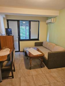 a living room with a couch and a table at Rooms Kristi in Nesebar