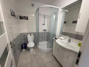 a bathroom with a shower and a toilet and a sink at Jurič in Rogoznica +28 photos