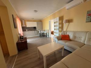 a living room with a couch and a table at Jurič in Rogoznica