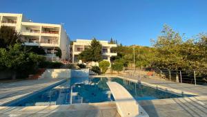 a swimming pool in front of a building at Sunset Spille in Rrogozhinë