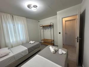 een slaapkamer met twee bedden en een deur naar een kamer bij Villa secrecy in Lixouri