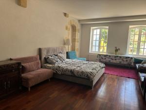 a bedroom with a bed and a couch and a chair at Bordeaux Castle natural No2 in Quinsac