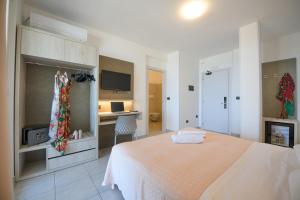 a bedroom with a bed and a desk at Hotel Graziella in Martinsicuro