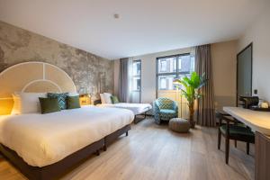 Postel nebo postele na pokoji v ubytování Leonardo Hotel Breda City Center