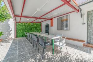 a dining room with a table and chairs on a patio at El Cortijo de Palma in Villarejo de Salvanés
