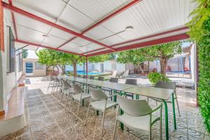 an outdoor patio with a long table and chairs at El Cortijo de Palma in Villarejo de Salvanés