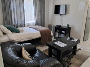 Habitación pequeña con cama y sofá en House of Grace Apt, en East London