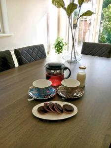a table with two plates of donuts on it at Shangri - La Spacious Family Townhouse in Killarney