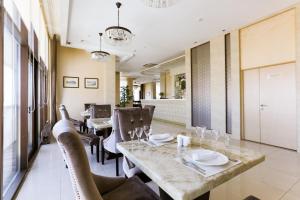 a dining room with a table and chairs at Hotel Sagaan Morin in Ulan-Ude