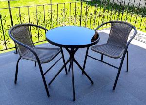 two chairs and a blue table and a table and chairs at Vila Green by Plaiul GreenBike in Deva