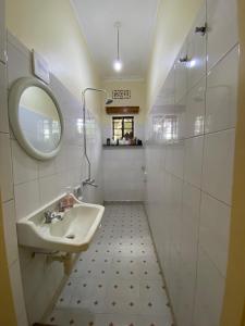 a bathroom with a sink and a mirror at Casa Mianzini in Arusha +14 photos