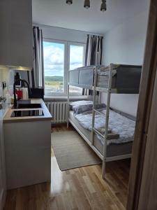 a kitchen with a bunk bed in a room at STUDIO dla 2 osób in Suwałki