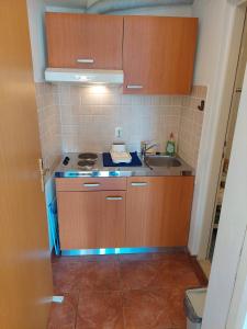 a small kitchen with a sink and a stove at Apartment Nona in Korčula