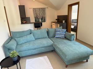 a blue couch in a living room at Villa Verde Oliva in Kamenari