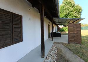 a porch of a house with a wooden door at HÁRS meg az alja in Balatonszárszó