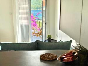 a table in a room with a view of a patio at Villa Verde Oliva in Kamenari