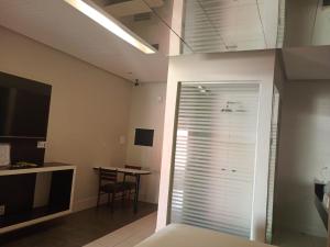 a room with a sliding glass door with a table at STILLUS - Hotel e Motel in Imperatriz +1 photo