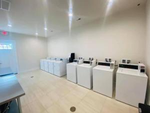 a laundry room with a bunch of washers and dryers at Vacation Cottage North Myrtle Beach #68 in Myrtle Beach