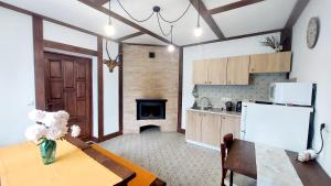a kitchen with a wooden table and a refrigerator at Під Боржавою in Pilipets