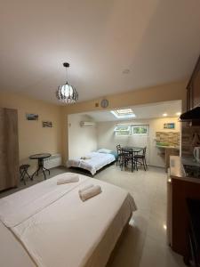 a bedroom with two beds and a table in it at Kobuleti Rooftop Hotel in K'obulet'i