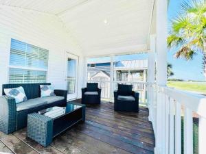 a porch with chairs and a couch and a table at Vacation Cottage North Myrtle Beach #67 in Myrtle Beach