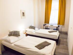 three beds in a room with yellow curtains at Classic room E5 Prague centre in Prague