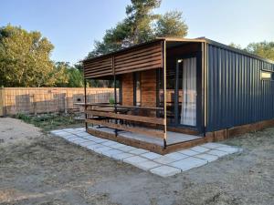 a tiny house on a concrete slab in a yard at Corner Bungalow in Ulcinj