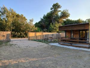a building with a bench and a fence at Corner Bungalow in Ulcinj