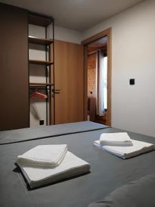 two white napkins sitting on top of a bed at Corner Bungalow in Ulcinj
