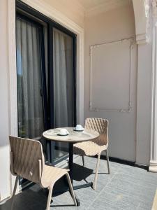 a dining room with a table and two chairs at Grand Vuslat Erdek in Erdek