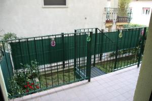 a green fence with christmas ornaments on it at Sotto la Rocca in Angera
