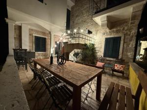 a dining room with a wooden table and chairs at Holiday home Teraca u Babe- in the town center in Omiš