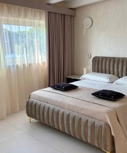 a hotel room with two beds and a window at Hotel Scilla in Scilla